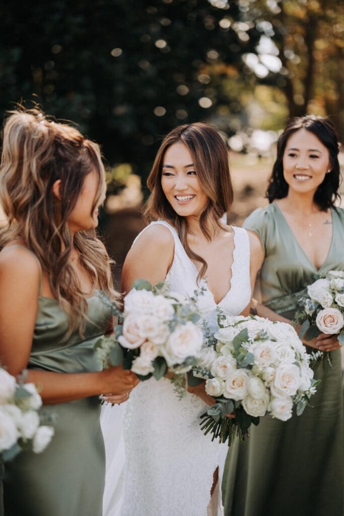 Bridal party holding coordinated garden rose bouquets with eucalyptus at TPC Sugarloaf wedding