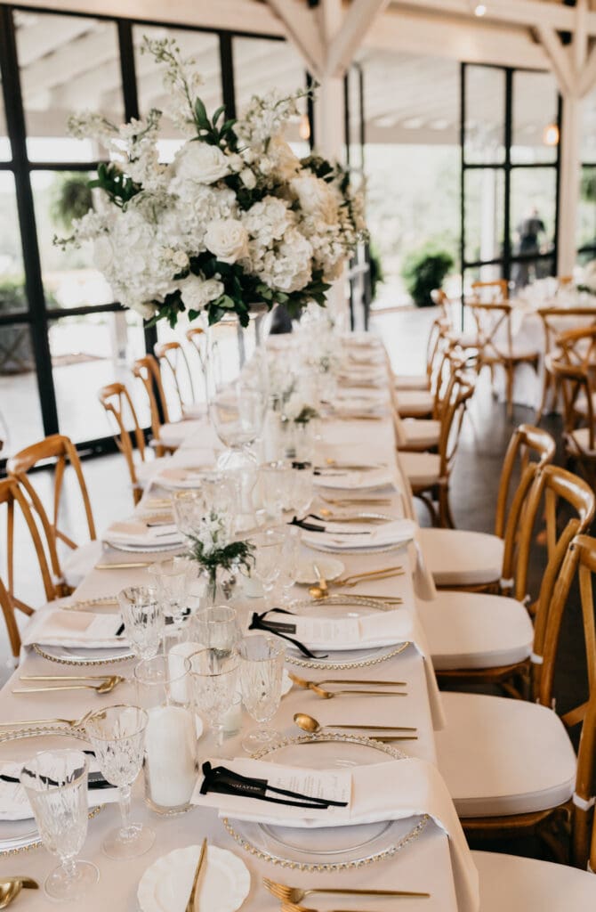 Tall centerpieces on glass vases elegant reception at Meadows at Mossy Creek