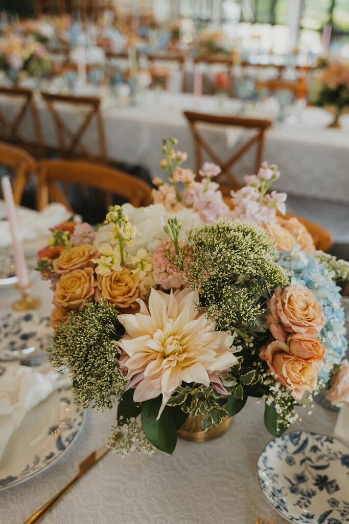 Garden style centerpiece with pastel flowers at Meadows at Mossy Creek reception venue