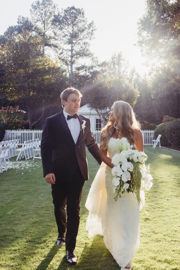 Golden hour photos of cascading white orchid bridal bouquet at Greenfield Farms wedding in Cumming Georgia