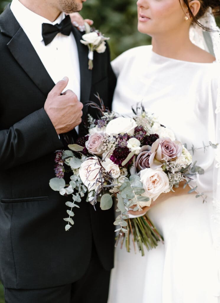 Bride holding romantic blush and ivory bouquet at Payne-Corley House outdoor wedding ceremony