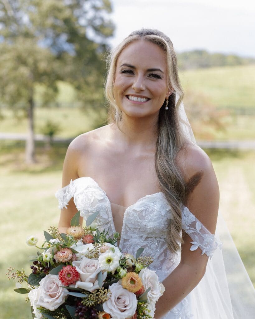Bride holding fall bouquet at White Oaks Vineyard in Dahlonega