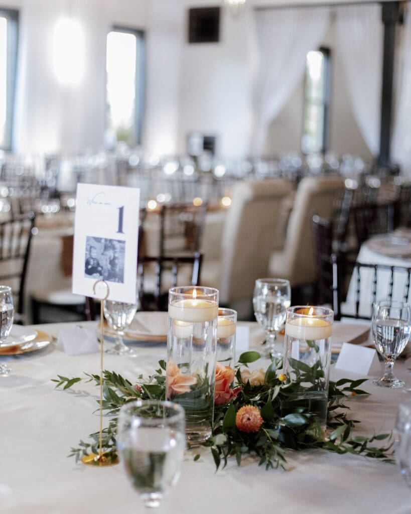 Floating candle centerpiece with greenery and blooms at White Oaks Vineyard Wedding 