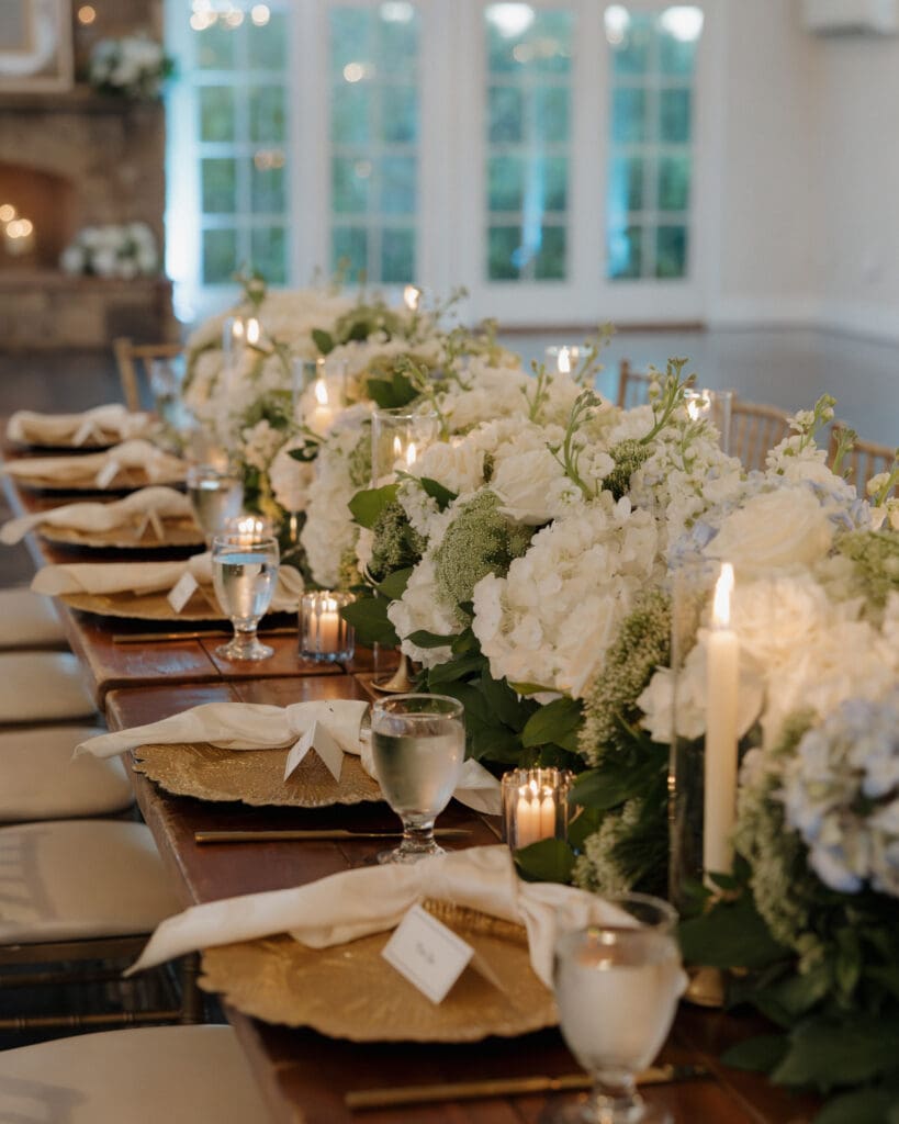 Candlelit reception tablescape with white hydrangea and roses at Little River Farms wedding