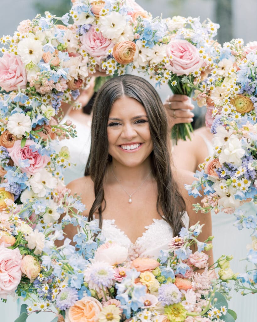 Colorful bouquets surround bride at The Revere Wedding Venue