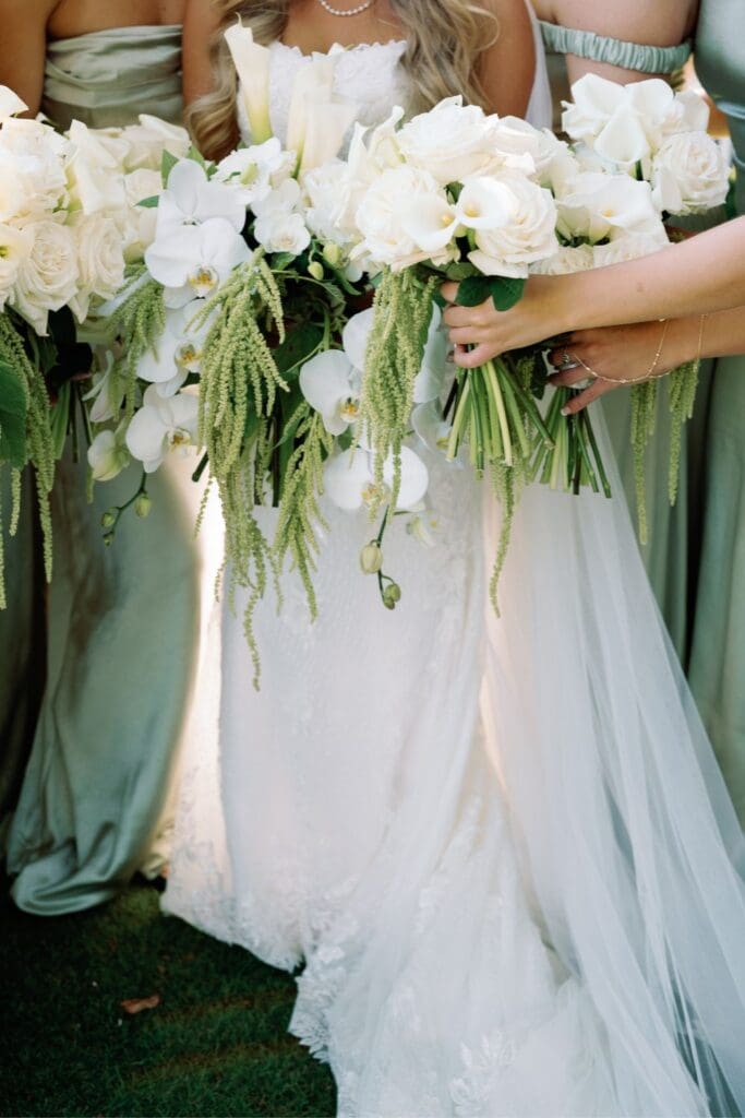 White rose, orchid, and calla lily bouquets with cascading greenery for a Greenfield Farm wedding.