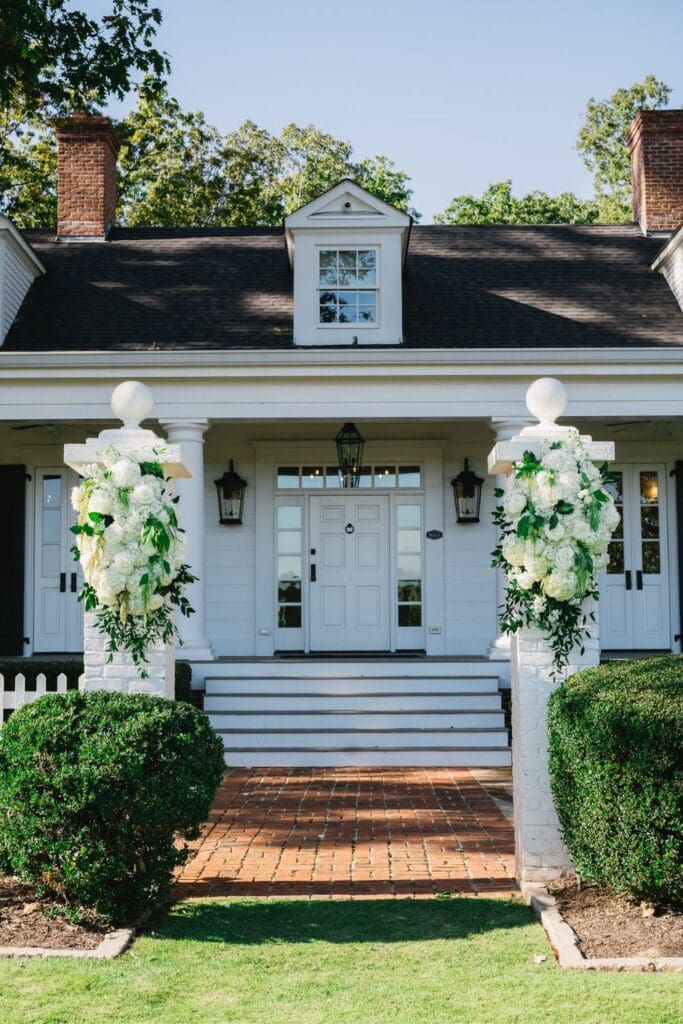 Elegant white floral columns decorating the entrance of Greenfield Farm wedding venue.