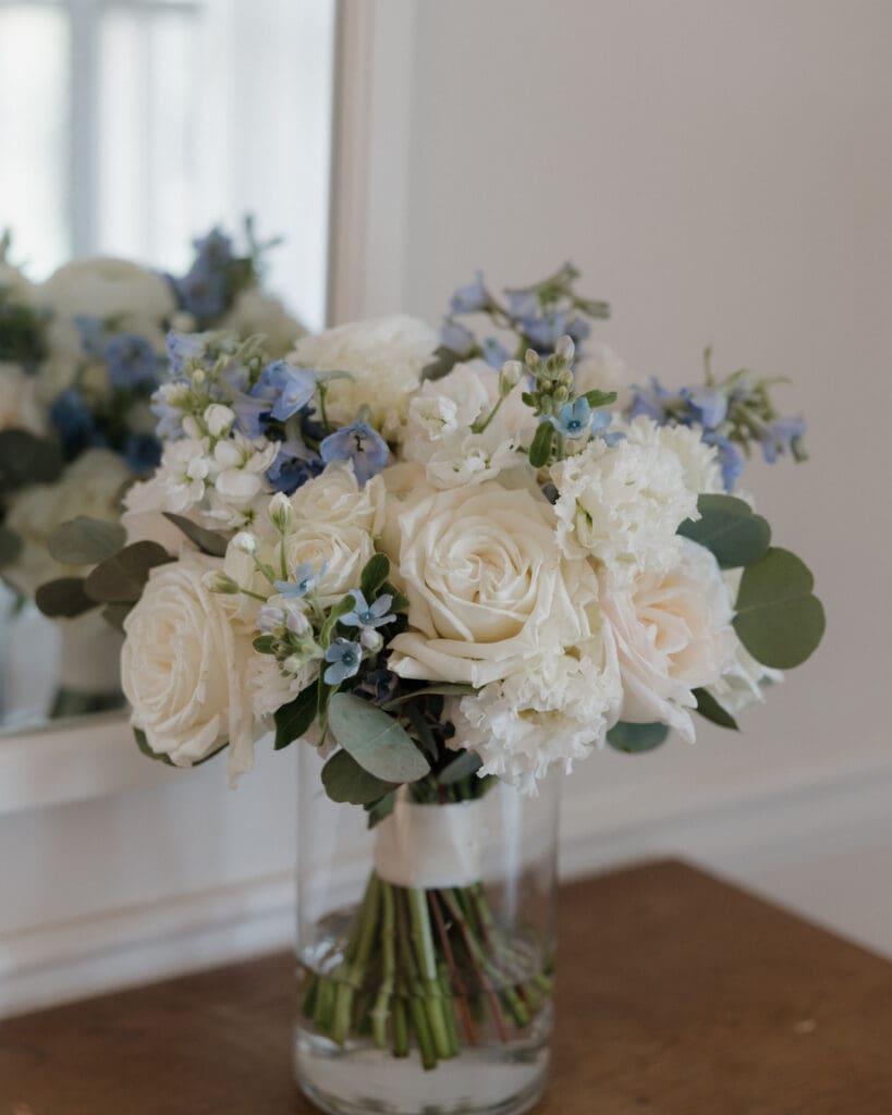 White and blue garden rose bouquet with light blue delphinium at Little River Farms wedding in North Georgia