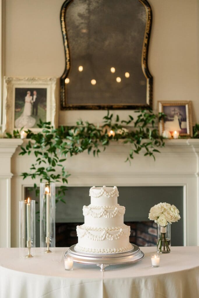 Classic white tiered wedding cake displayed with candles at elegant Atlanta wedding reception