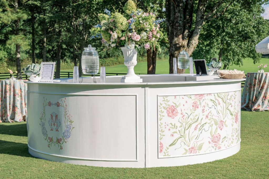 Elegant reception bar with floral arrangements at Greenfield Farms wedding venue