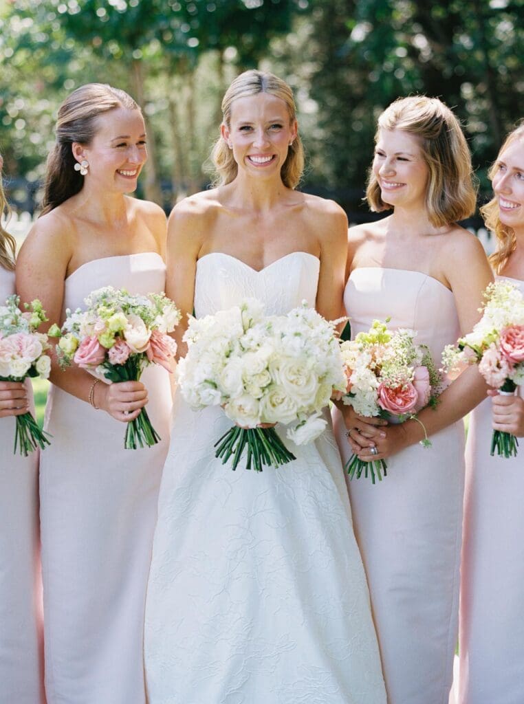 Bride with bridesmaids holding romantic wedding bouquets at Greenfield Farms