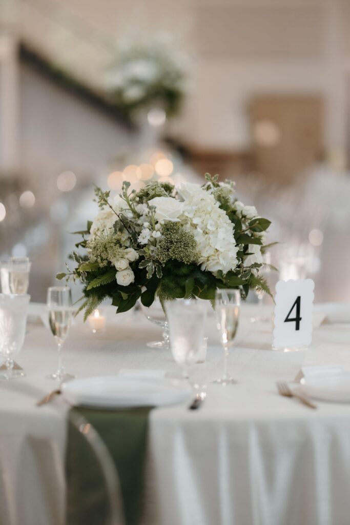 White and green wedding centerpiece with hydrangea and roses at The Revere in Dawsonville